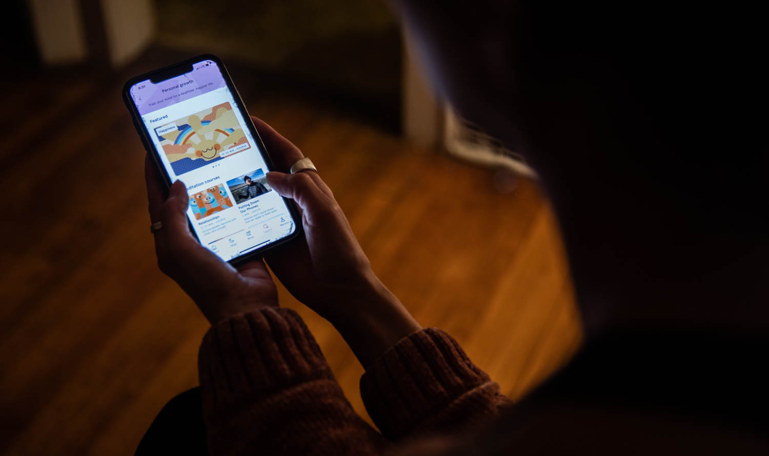 Photo of someone holding a phone, using an app
