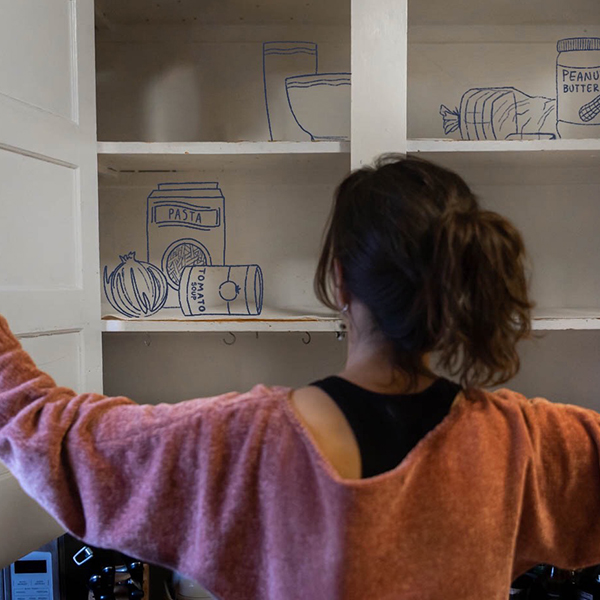 girl lookinng in empty cabinet